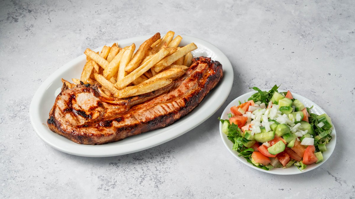 Grilled meat portions served with chips and salad at I Xrisi Smila, Larnaca